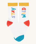 A close up of the white sock with the stay wild slogan from the Frugi rock my socks 3 pack in stay wild available at Babipur.