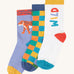 Frugi rock my socks 3 pack in stay wild multipack available at Babipur. GOTS organic cotton socks including a light purple with a tiger design, a checkered design and a white sock with stay wild slogan.