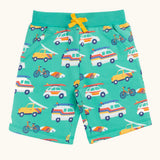 Frugi 100% organic cotton shorts in light green with repeating beach theme vehicles. Shows side pockets and yellow waist tie