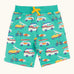 Frugi 100% organic cotton shorts in light green with repeating beach theme vehicles. Shows side pockets and yellow waist tie