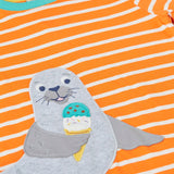 Frugi 100% organic cotton short sleeve t-shirt in orange and white stripes laid flat showing  a seal patch on the front 