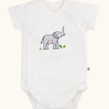 Frugi 100% organic cotton baby bodysuit in white with a small elephant print. Shows full length front and crotch popper fastener 