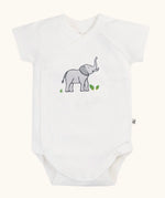 Frugi 100% organic cotton baby bodysuit in white with a small elephant print. Shows full length front and crotch popper fastener 