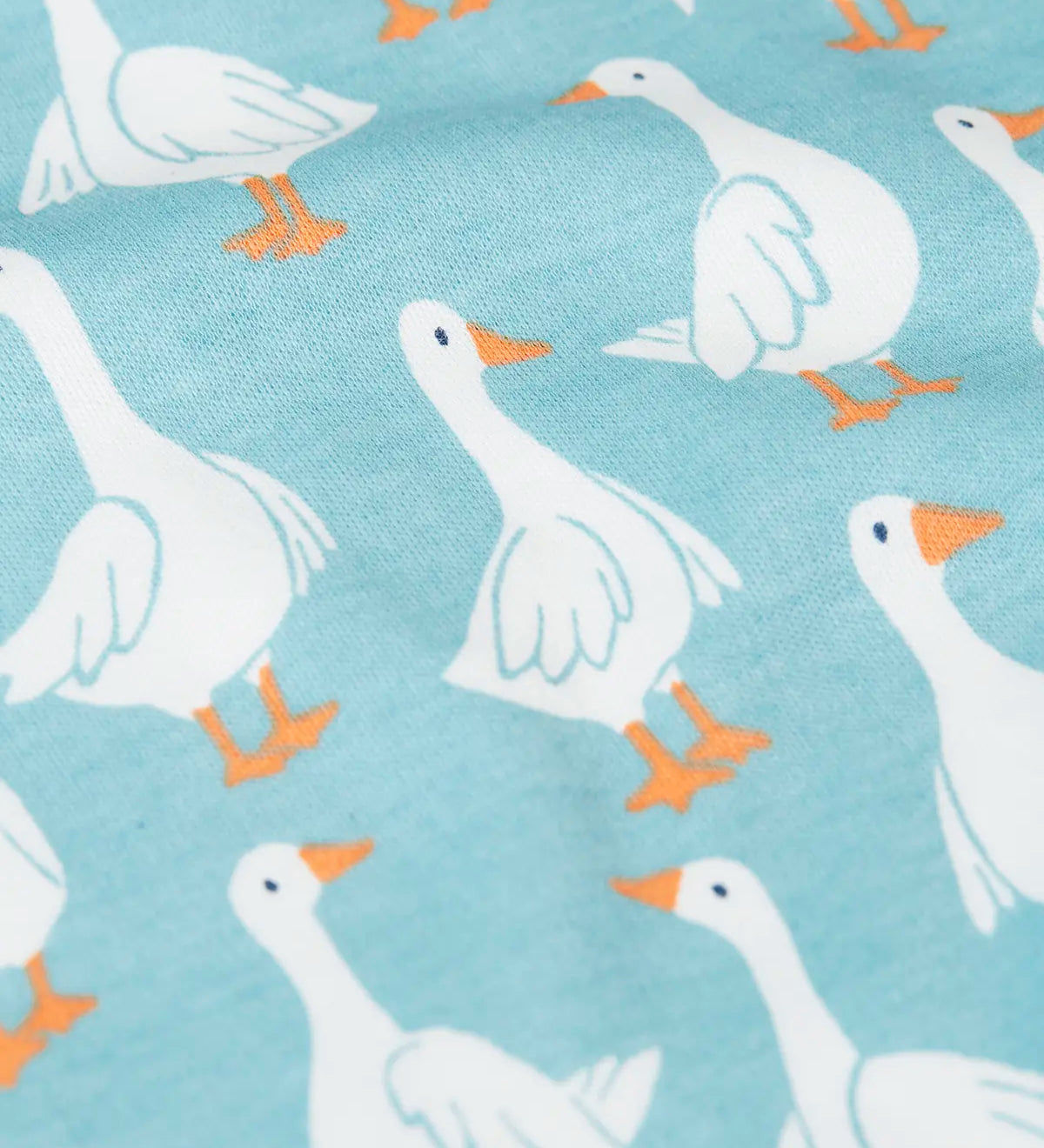 Close up of the repeating white goose design on the Frugi 100% organic cotton snooze light blue pj set 