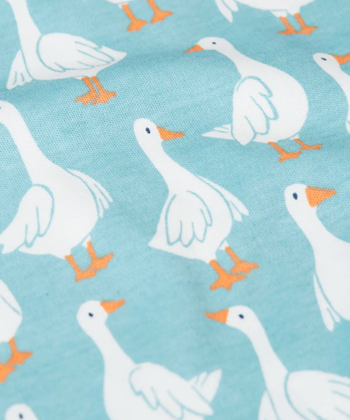 Close up of the repeating white goose design on the Frugi 100% organic cotton snooze light blue pj set 