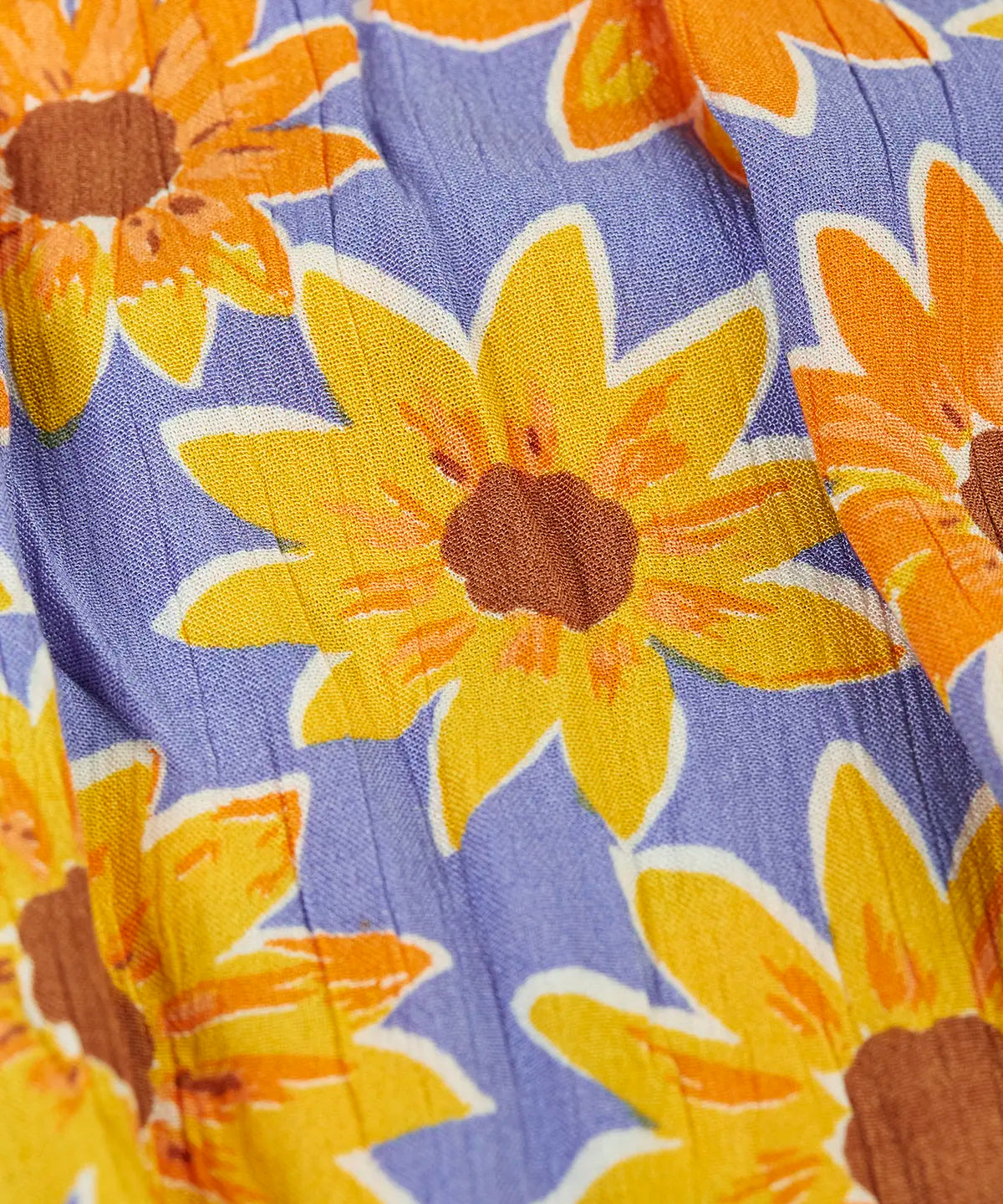 Close up the repeating sunflower design on the violet Frugi 100% organic cotton sophie summer dress