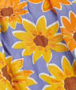 Close up the repeating sunflower design on the violet Frugi 100% organic cotton sophie summer dress