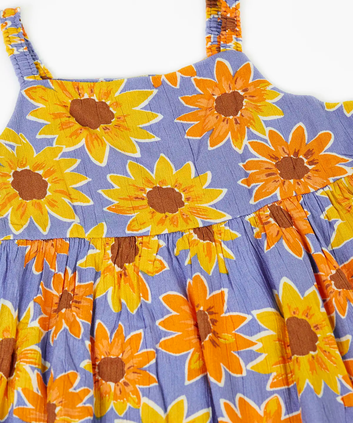 Frugi Sophie summer sleeveless dress in purple laid flat showing repeating sunflower design and shoulder straps
