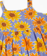Frugi Sophie summer sleeveless dress in purple laid flat showing repeating sunflower design and shoulder straps
