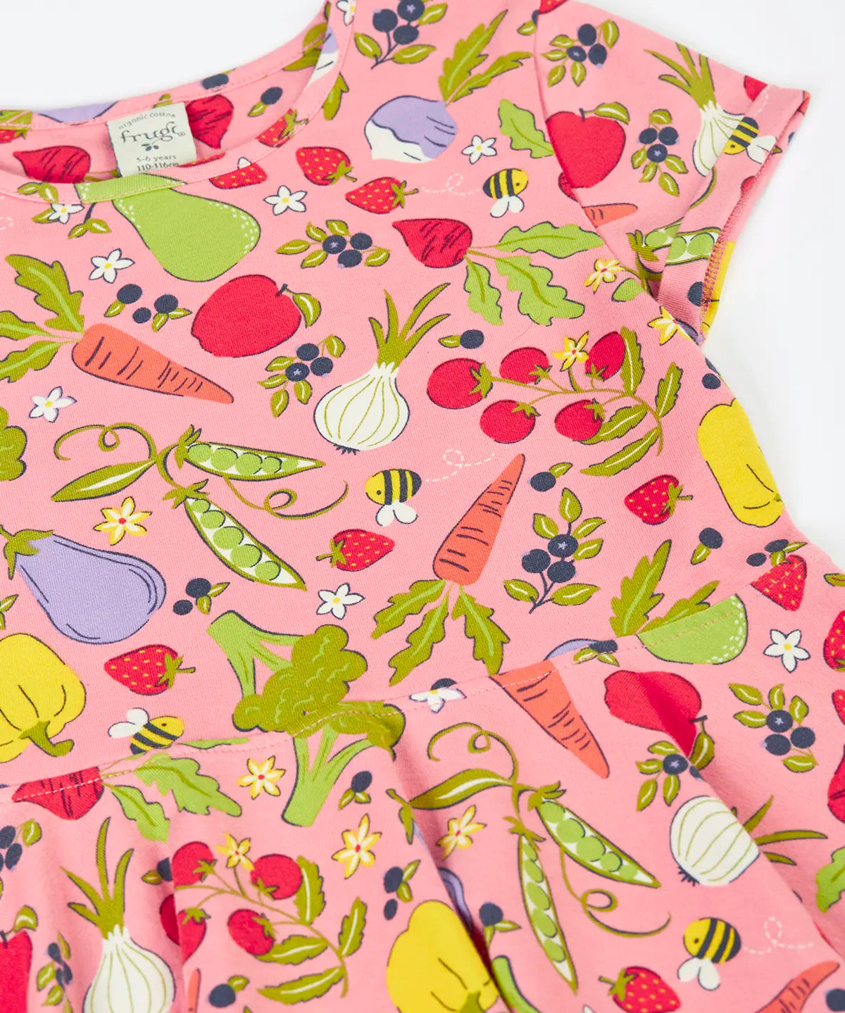 Frugi's 100% organic cotton spring skater dress in pink laid flat showing the repeating fruit and veg print 