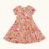 Frugi 100% organic cotton spring skater dress in pink with a repeating fruit and veg print.