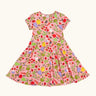 Frugi 100% organic cotton spring skater dress in pink with a repeating fruit and veg print.