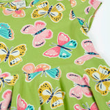 Frugi 100% organic cotton spring skater dress in green laid flat showing the repeating colourful butterfly print.