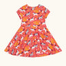 Frugi 100% spring skater dress in coral pink with repeating prints of grey and white horses