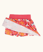 Frugi spring skort in coral pink with a repeating white and grey pony print showing the shorts underneath