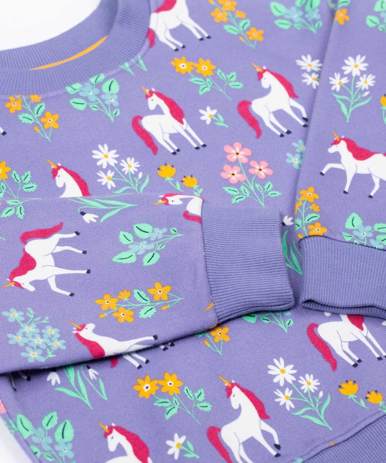 A close up of the wrist cuffs on the Frugi superb sweatshirt in unicorn floral available at Babipur. A soft GOTS organic cotton sweatshirt in lilac with a unicorn and floral print all over.