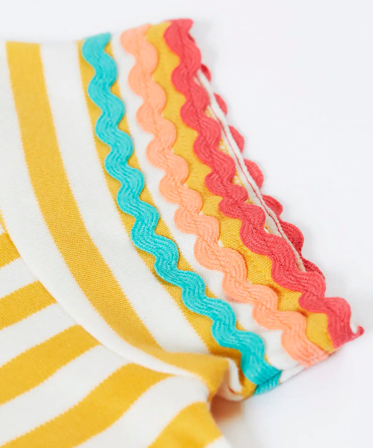Close up of Frugi 100% organic cotton Thea yellow and white stripe short sleeve t-shirt showing ric rac decorative trim on the sleeves