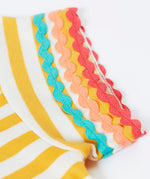 Close up of Frugi 100% organic cotton Thea yellow and white stripe short sleeve t-shirt showing ric rac decorative trim on the sleeves