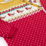 A close up of the Frugi lumi knitted festive romper fair isle available at Babipur. A GOTS organic cotton soft knitted all in one in a fairisle design with robins. Features button fasteners running down from the shoulder.