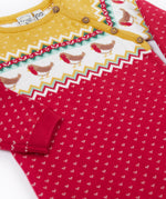 A close up of the Frugi lumi knitted festive romper fair isle available at Babipur. A GOTS organic cotton soft knitted all in one in a fairisle design with robins. Features button fasteners running down from the shoulder.