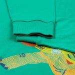Frugi kids green stop in a green colour with a triceratops design embroidery and cuff detail