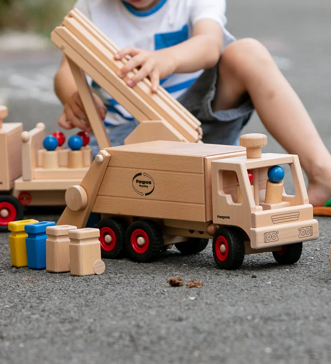 Fagus garbage tipper, a wooden rubbish van with working tipping mechanism, four peg dolls and wheelie bins.