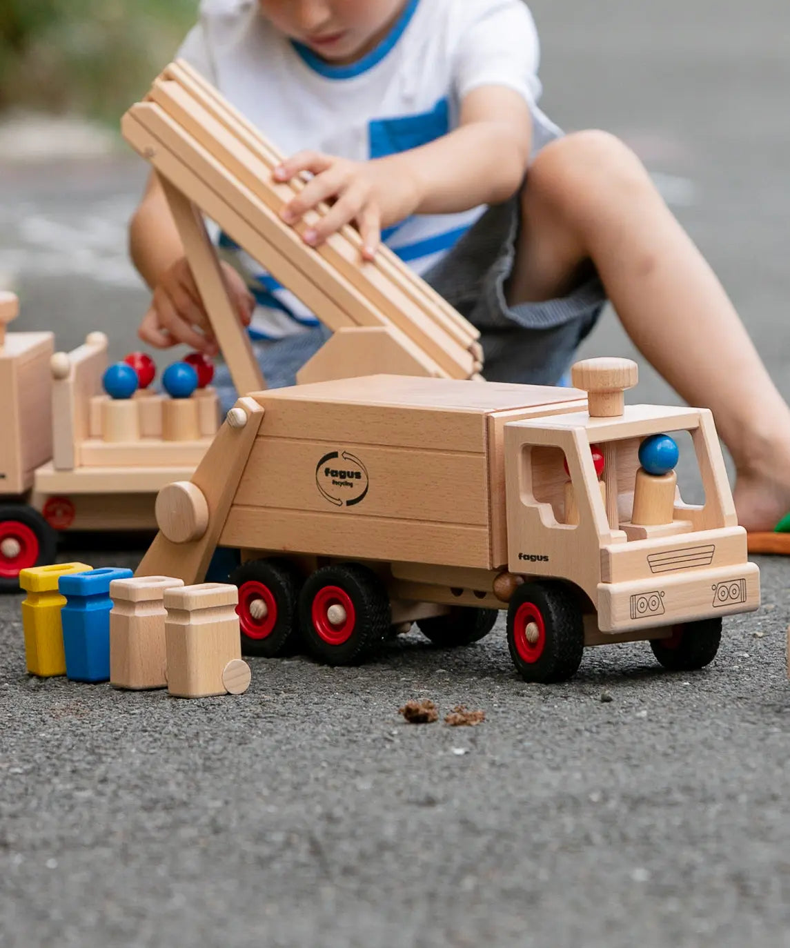 Fagus garbage tipper, a wooden rubbish van with working tipping mechanism, four peg dolls and wheelie bins.