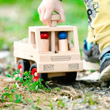 Fagus unimog, a classic wooden toy truck with working steering, rubber wheels and two peg dolls.