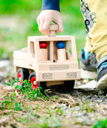 Fagus unimog, a classic wooden toy truck with working steering, rubber wheels and two peg dolls.
