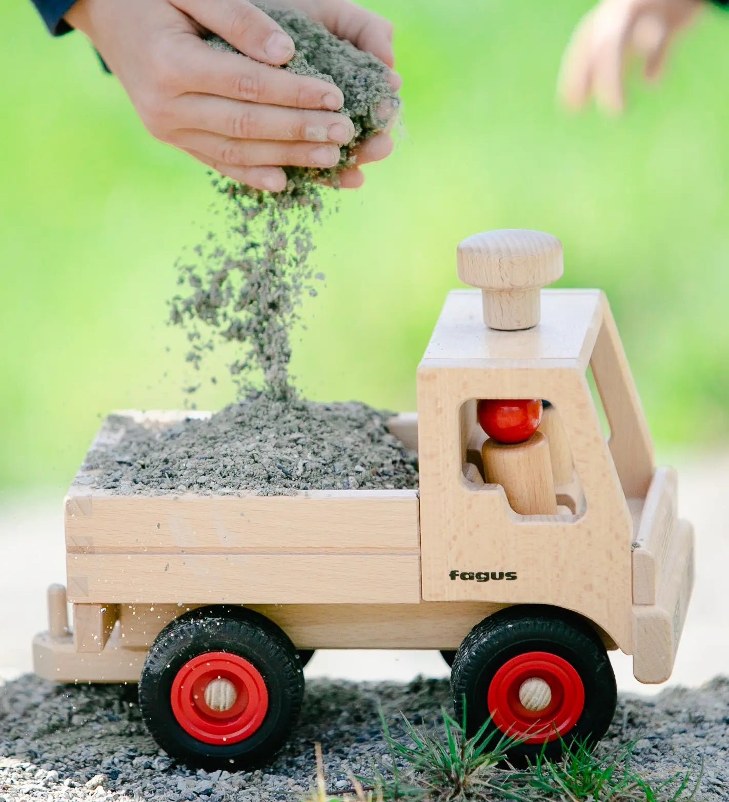 Fagus wooden toy truck, with working steering, a tow bar, rubber wheels and two Fagus peg dolls.