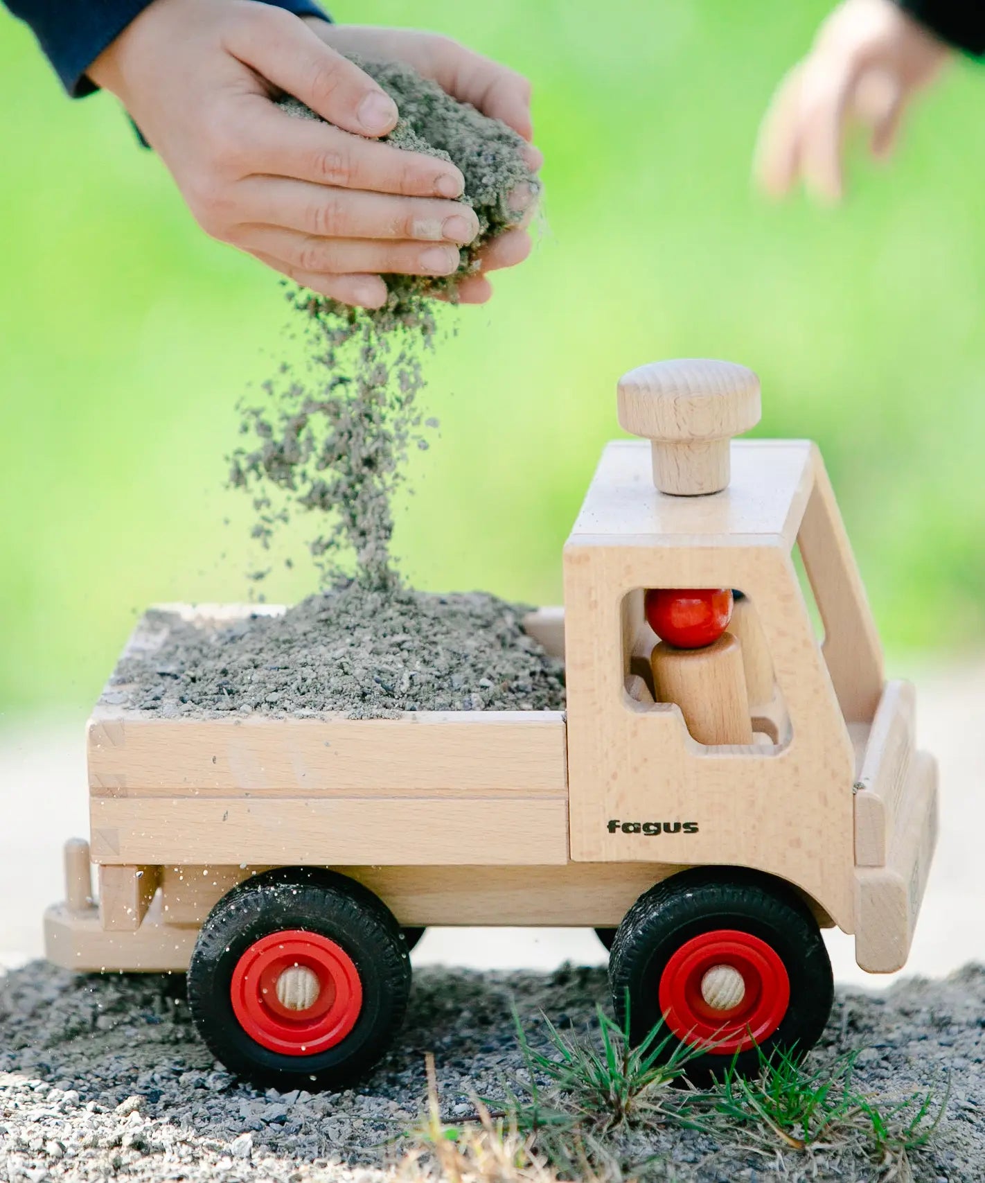 Fagus wooden toy truck, with working steering, a tow bar, rubber wheels and two Fagus peg dolls.