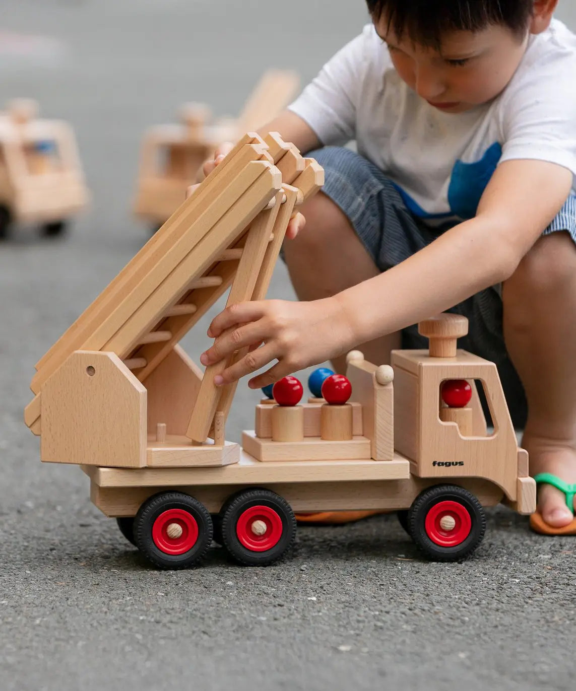 Fagus wooden fire engine toy, heirloom quality with an extendable rotating 3-piece ladder, rubber wheels and 6 peg doll figures.