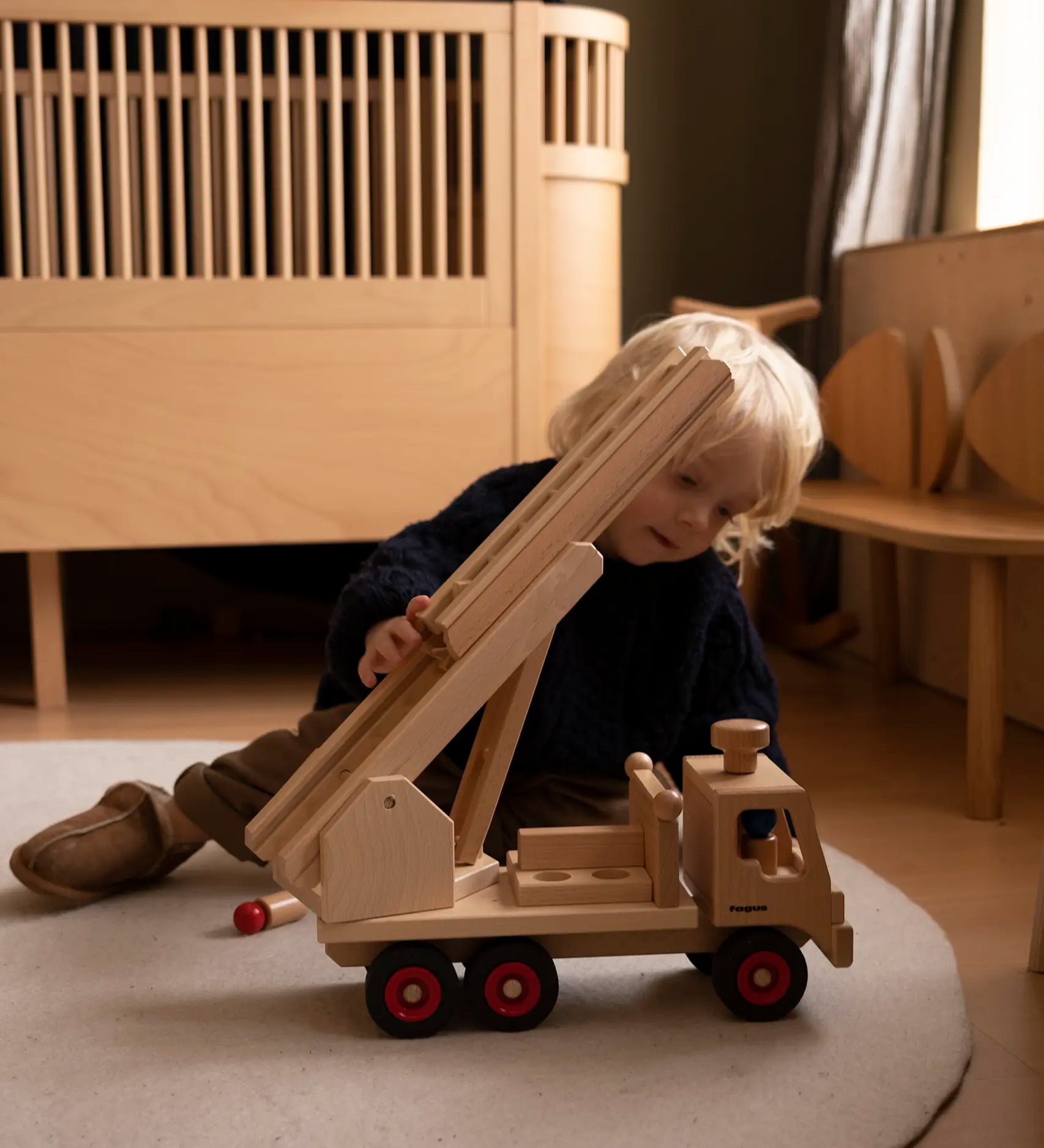 Fagus fire engine wooden toy with heirloom quality, an extendable rotating 3-piece ladder, rubber wheels and 6 peg doll figures.