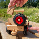 Fagus Jeep Wooden Car, with a spare spinning wheel on the back, a tow hitch for Fagus trailers and a detachable reserve jerry can.
