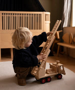 Fagus fire engine wooden toy featuring an extendable rotating 3-piece ladder, working steering and 6 peg doll figures.