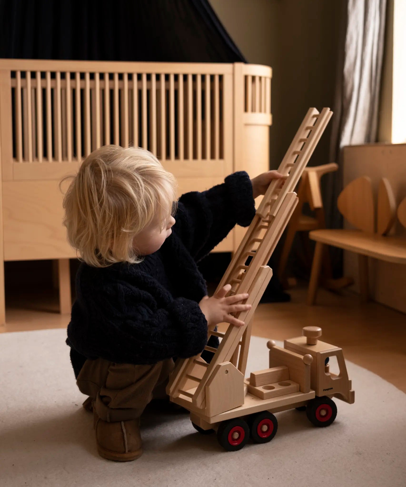 Fagus fire engine wooden toy featuring an extendable rotating 3-piece ladder, working steering and 6 peg doll figures.