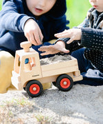 Fagus unimog, kids wooden toy truck with tow bar, working steering and rubber wheels, played with by kids outside.