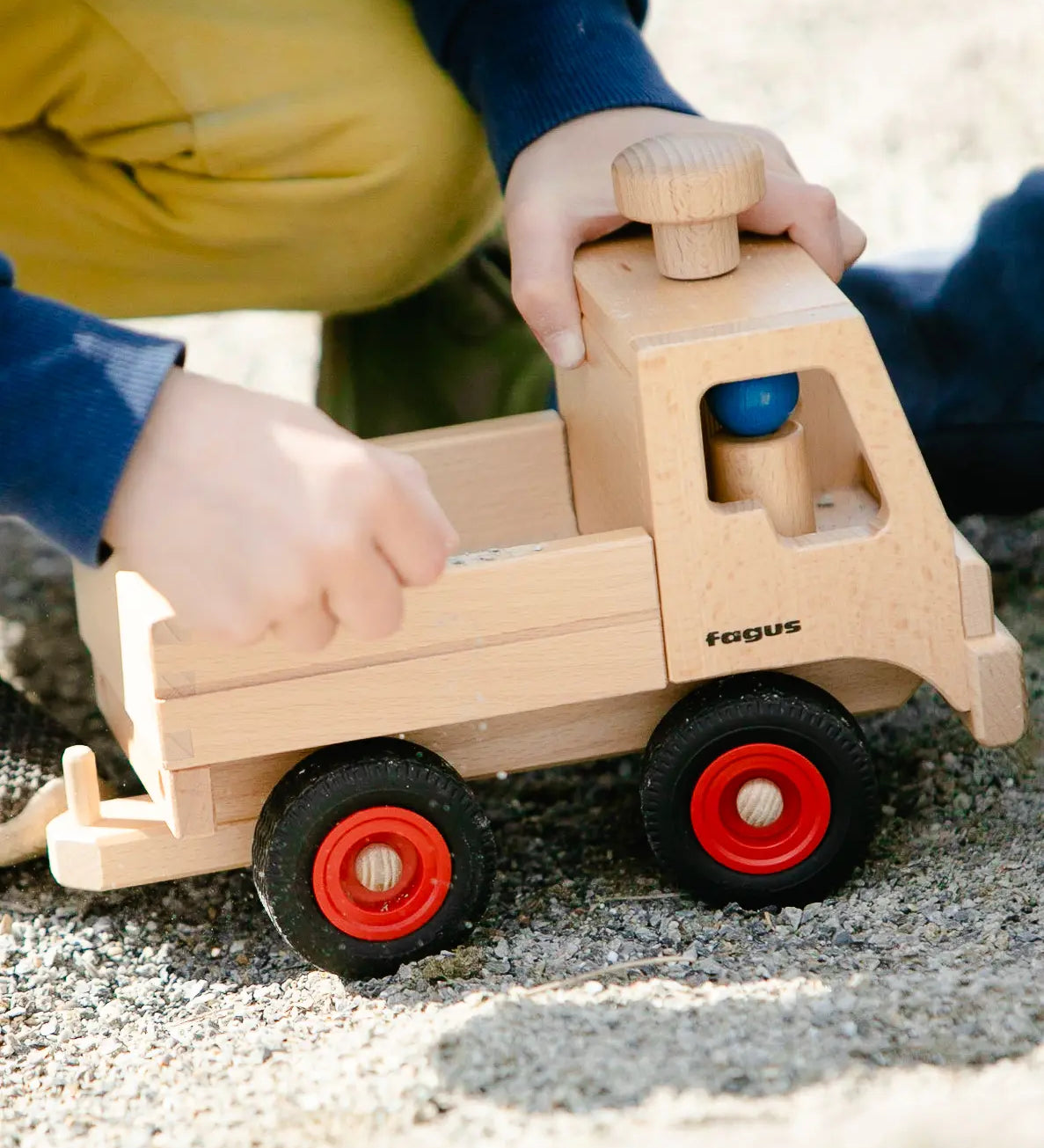 Fagus Wooden Unimog truck with tow bar, rubber wheels and blue peg doll.