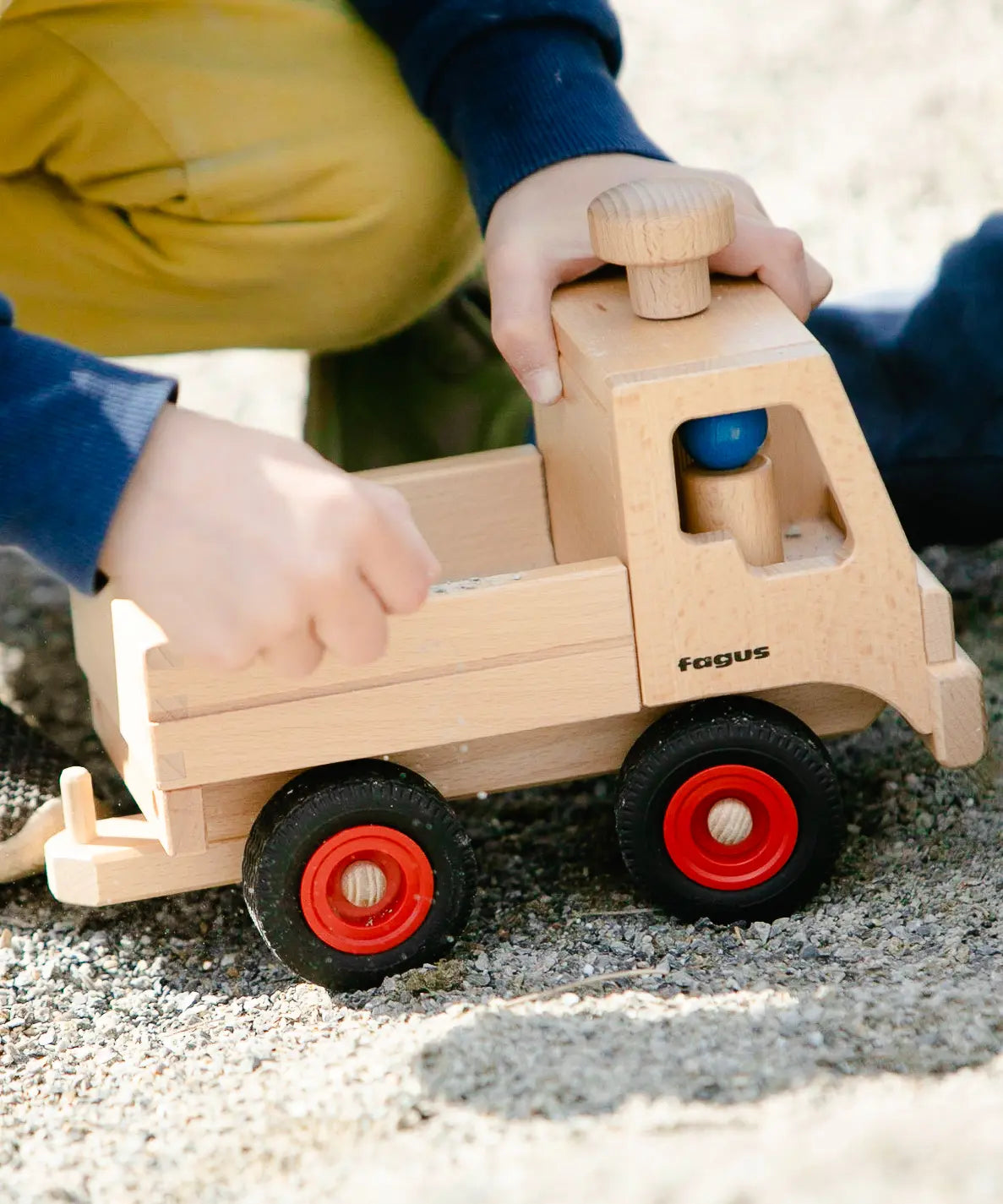 Fagus Wooden Unimog truck with tow bar, rubber wheels and blue peg doll.