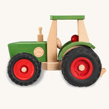 Fagus Wooden toy tractor with green body, red wheels, and beige seat on a white background