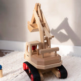 Fagus excavator toy, handmade with grippy rubber tracks and an adjustable scoop, plus two peg dolls for imaginative small world play.