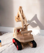 Fagus excavator toy, handmade with grippy rubber tracks and an adjustable scoop, plus two peg dolls for imaginative small world play.