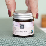 Fair Squared Fairtrade Apricot Plastic Free Lip Balm stored a glass jar, available to buy at Babipur.
