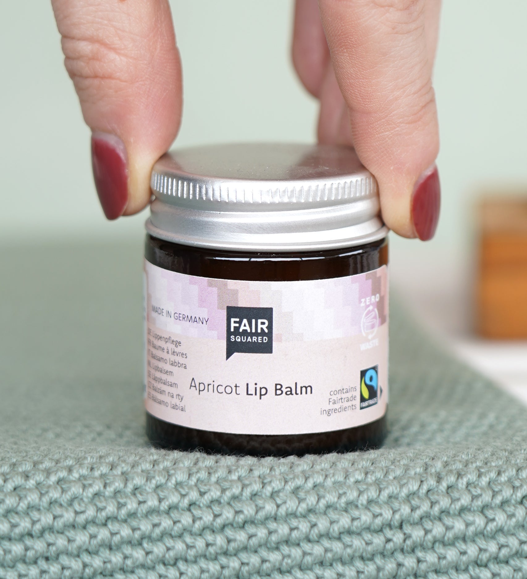 Fair Squared Fairtrade Apricot Plastic Free Lip Balm stored a glass jar, available to buy at Babipur.
