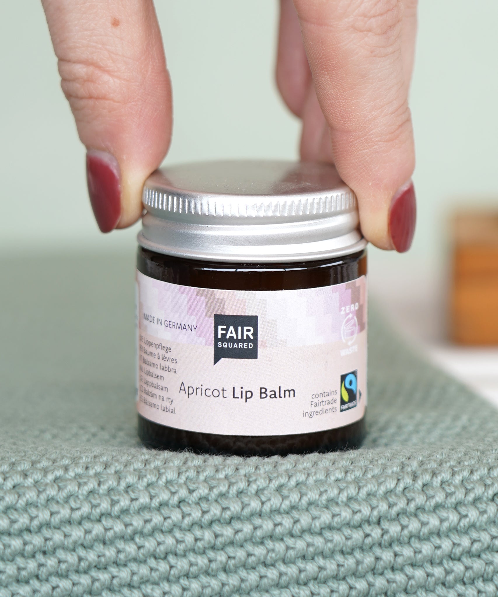 Fair Squared Fairtrade Apricot Plastic Free Lip Balm stored a glass jar, available to buy at Babipur.
