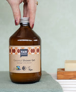 Plastic-free Fairtrade Coconut Shower Gel 500ml in a bathroom, by Fair Squared, available to buy at Babipur.
