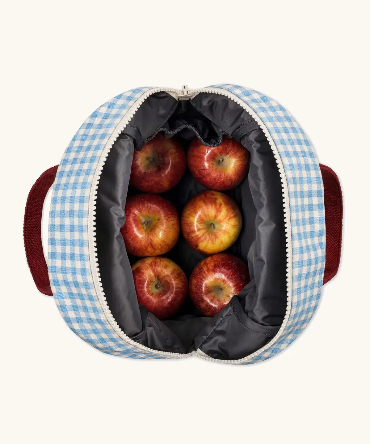 An open Fluf GOTS organic cotton zippered lunch bag in a white and blue gingham showing 6 apples inside and a interior pocket 