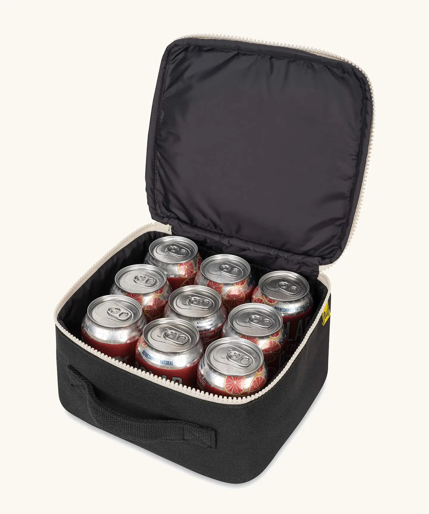 An open carbon black Fluf square lunch bag showing drink cans standing inside. Lunch bag features a a rinseable, food-safe lining