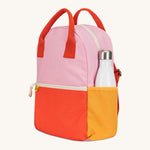 A side view of The organic cotton Fluf B-Pack Jr, a kids school backpack with a drink holder side pocket