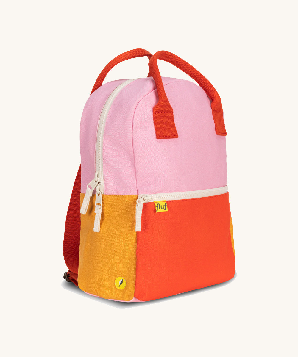 A side view of The organic cotton Fluf B-Pack Jr, a kids school backpack in a bright colour block design